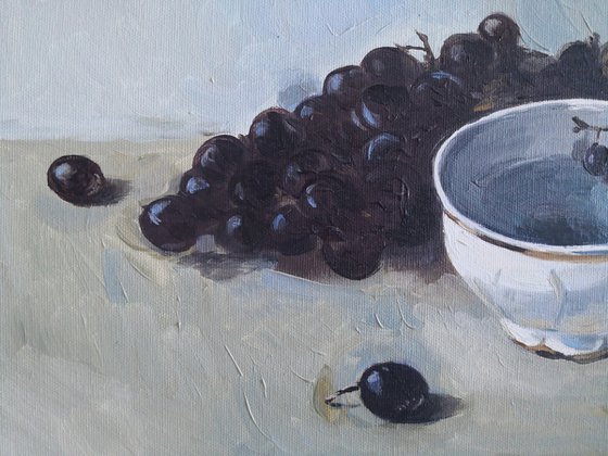 Black grapes and a porcelain cup still life