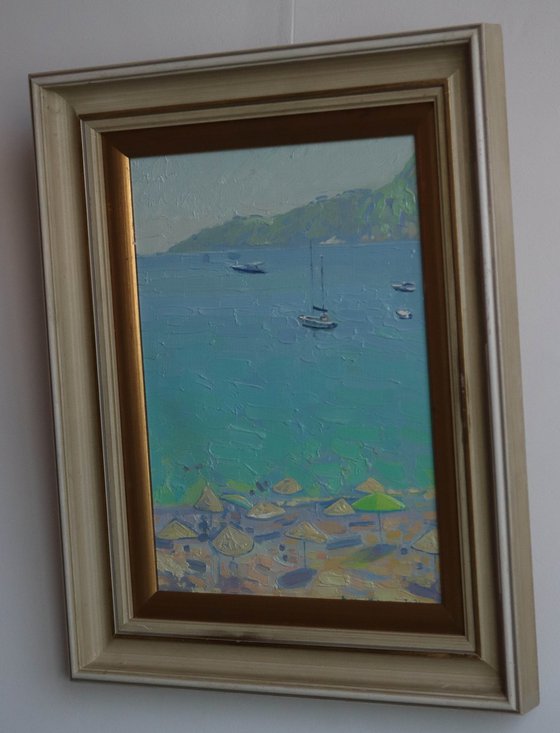 Yachts and umbrellas on the beach