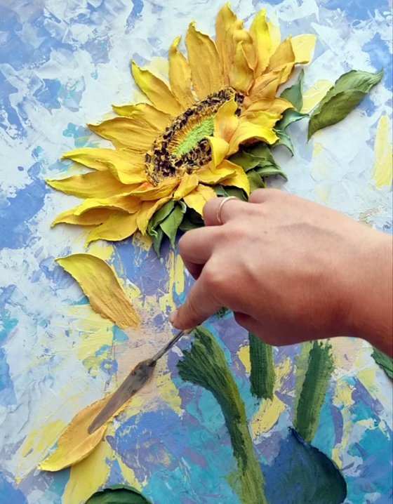 Sunflowers. Fragments of the summer sun. / floral still life relief with bright yellow flowers on a blue background