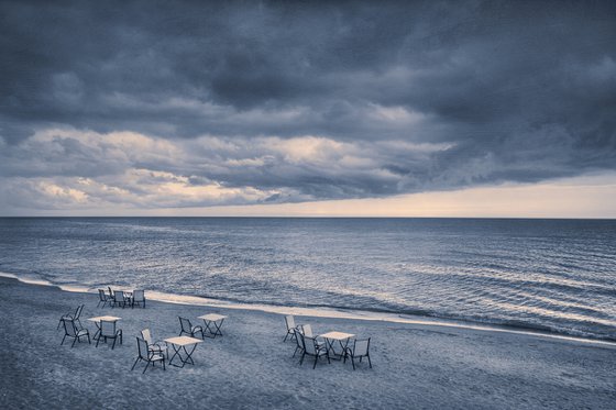 There are many empty seats in the coastal cafe before the storm.