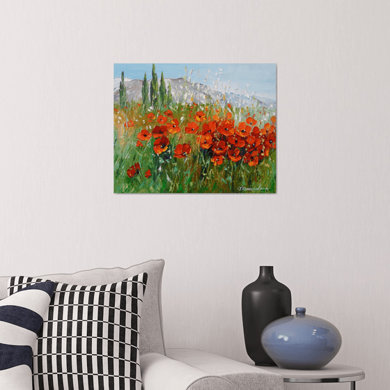 Field of poppies near the mountains