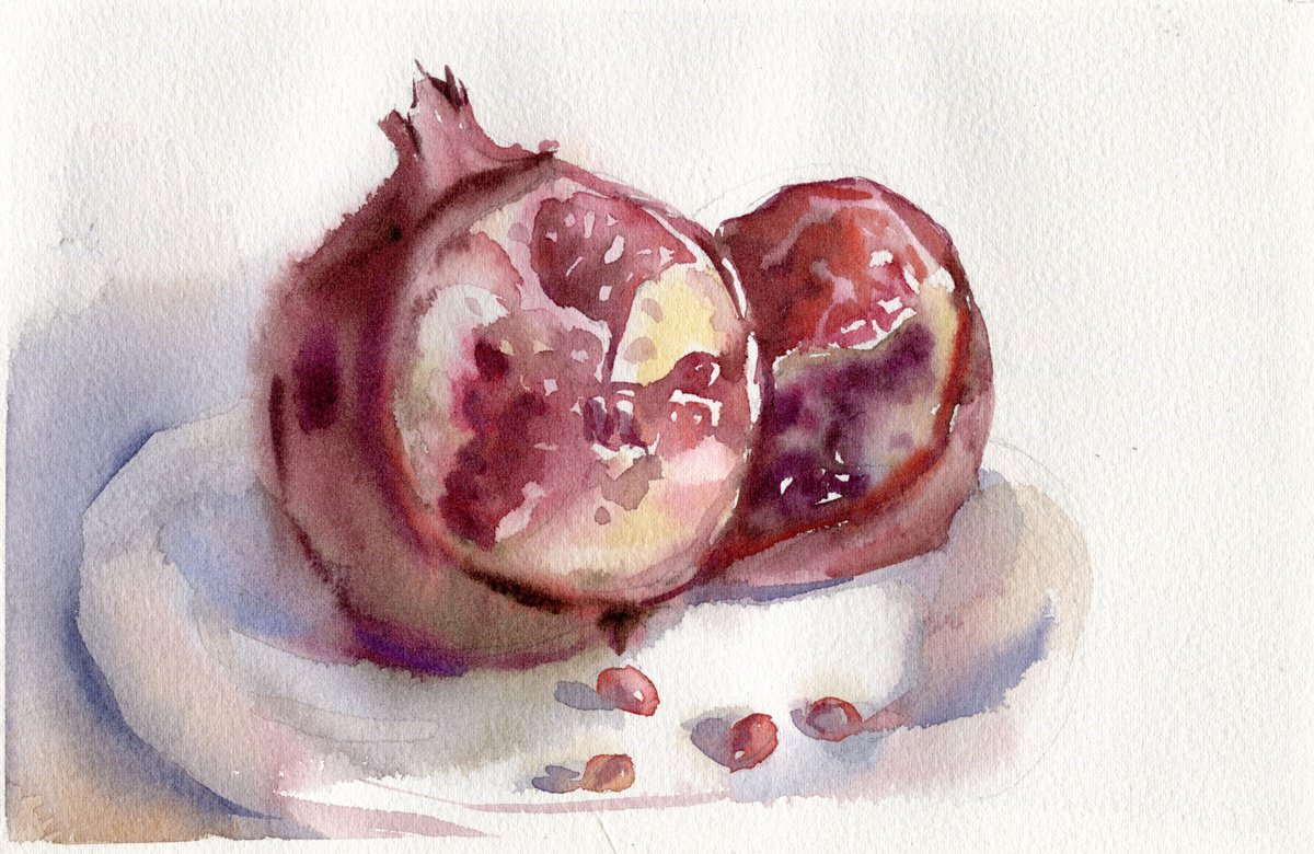 A cut pomegranate on a plate by SVITLANA LAGUTINA
