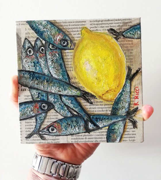 Fishes with Lemon on Newspaper