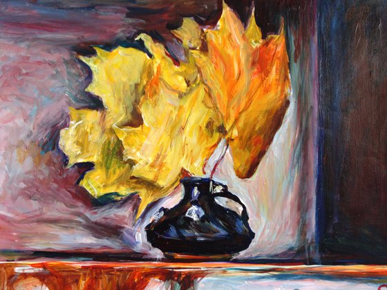 Black vase with autumn leaves