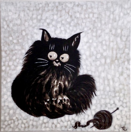 Black cat with a ball of wool