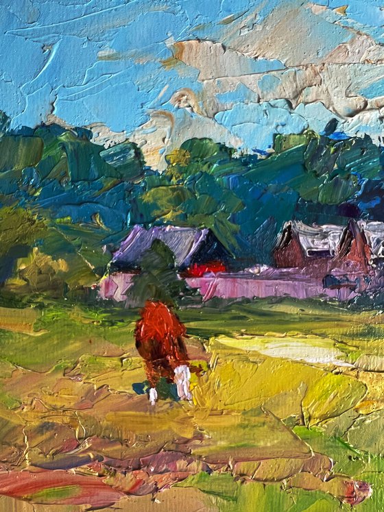 A Red Cow near the Houses