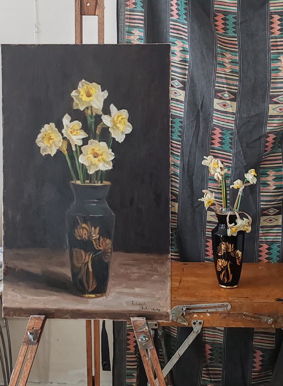 Five daffodils in a dark vase
