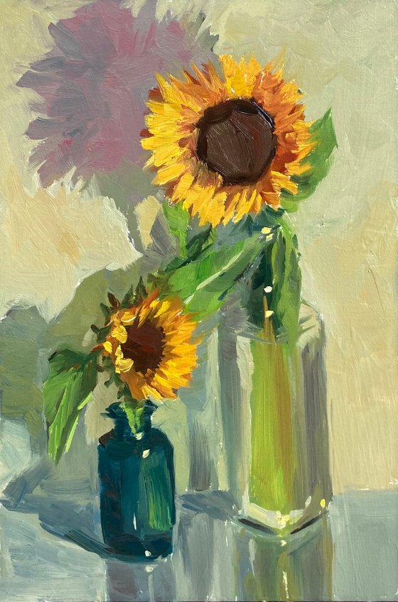 Sunflowers with a blue glass