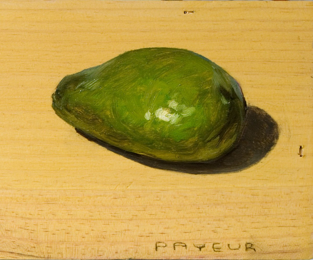 green avocado on a wood board for food lovers by Olivier Payeur