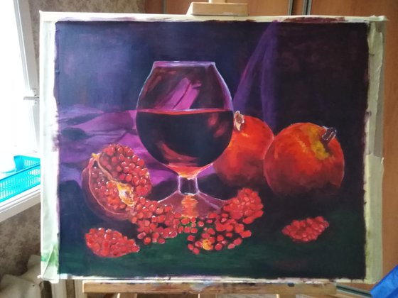 Ripe pomegranate and a glass of wine