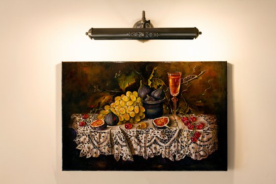 Still life with grapes and figs on a lace tablecloth