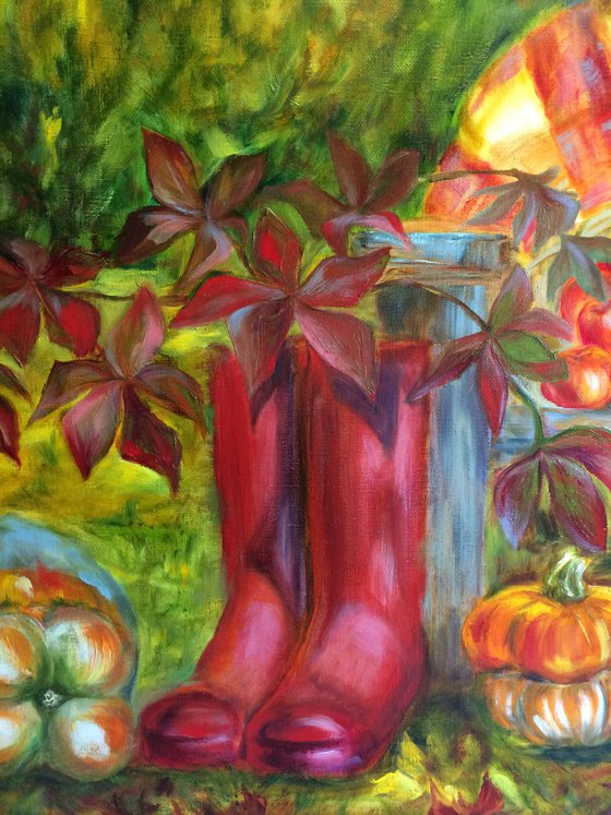 Still life with pink wellingtons, pumpkins and apples in garden