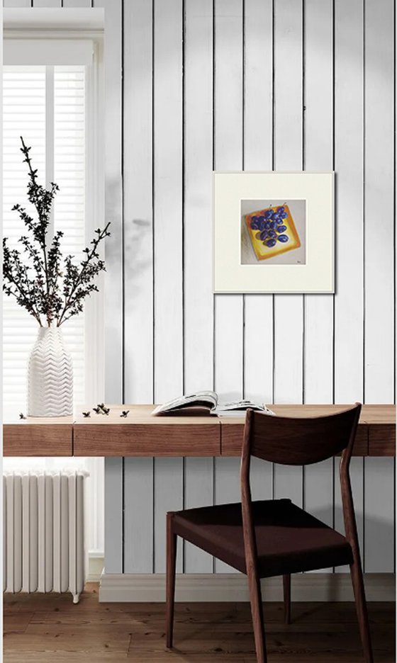 Blue plums on a yellow dish