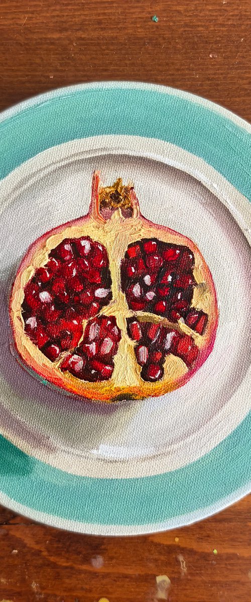 Pomegranate on plate by Leyla Demir