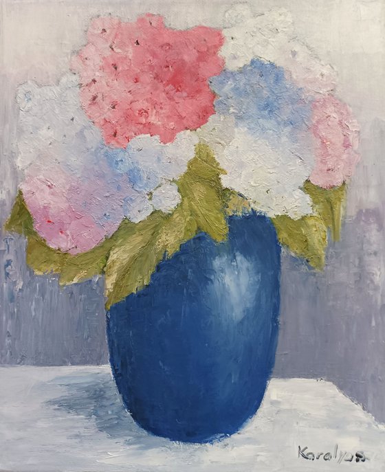 Blue vase with hydrangea flowers