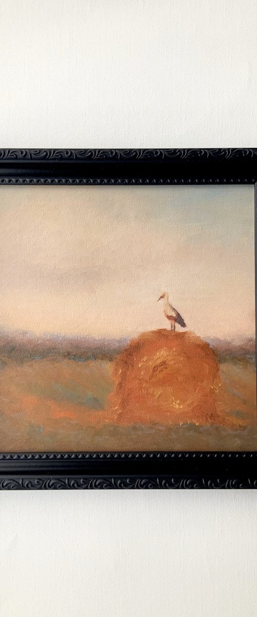 Stork on a haystack, in frame by Alena Post