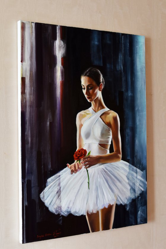 A ballet dancer with a red rose