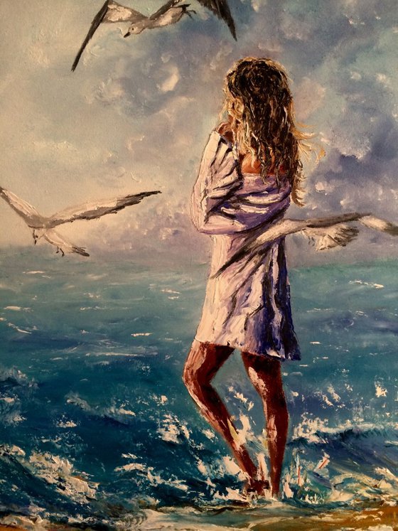 Girl with the seagulls at the beach