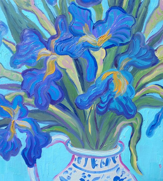 Vase of Irises with oranges.