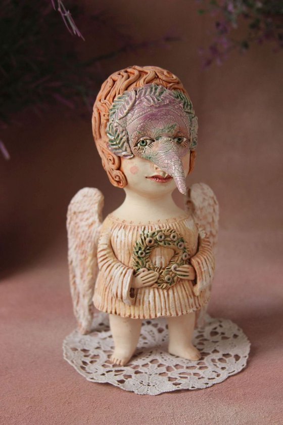 Angel holding a wreath. Ceramic OOAK sculpture.