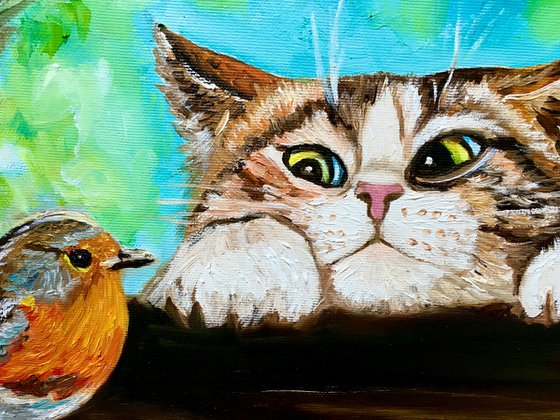Curiosity, feline look. Cat and robin.  Spring time.