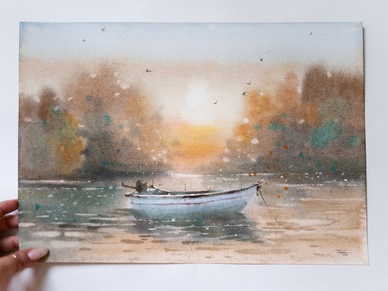 Autumn lake and fishing boat at sunrise