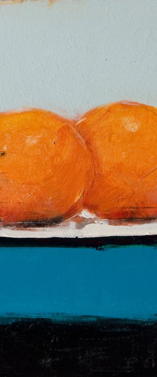 two oranges on blue by Olivier Payeur