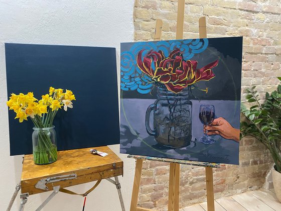Still life with a glass of gloriosa flower and a glass of red wine