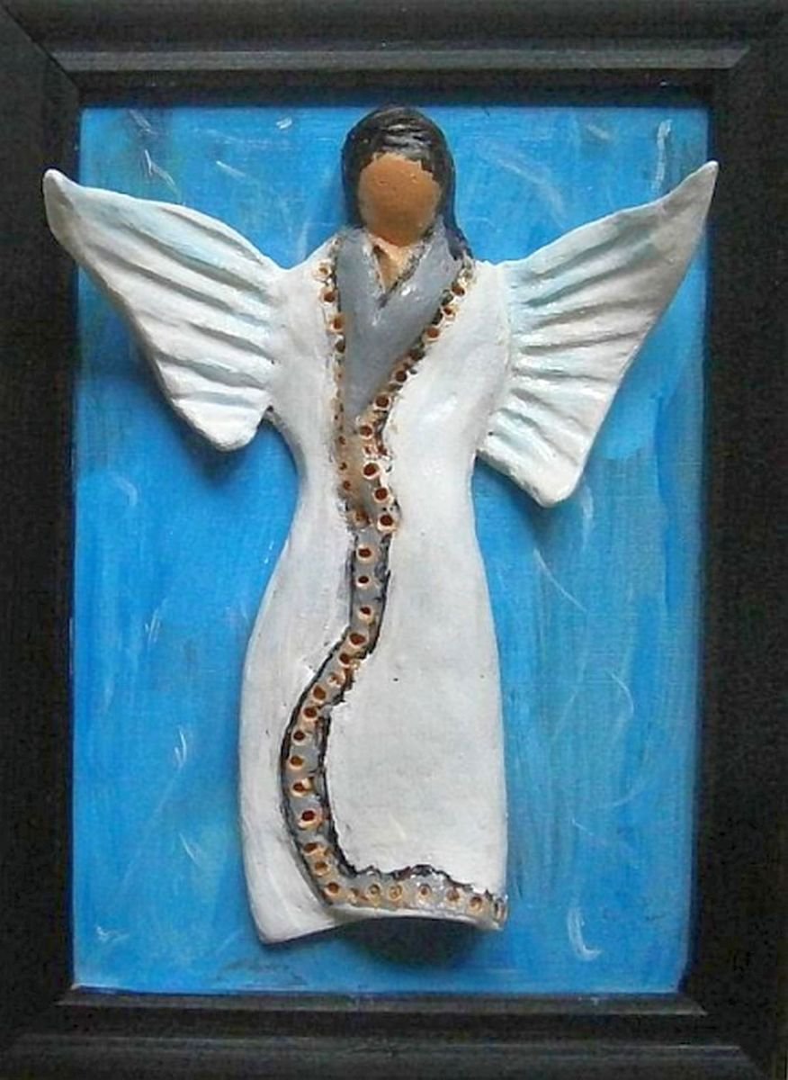Ceramic angel on a blue background .. by Emlia Urbankov