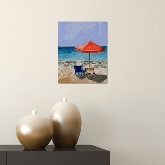 Red parasol on the beach.