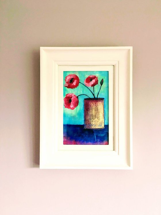 Poppies in gold vase