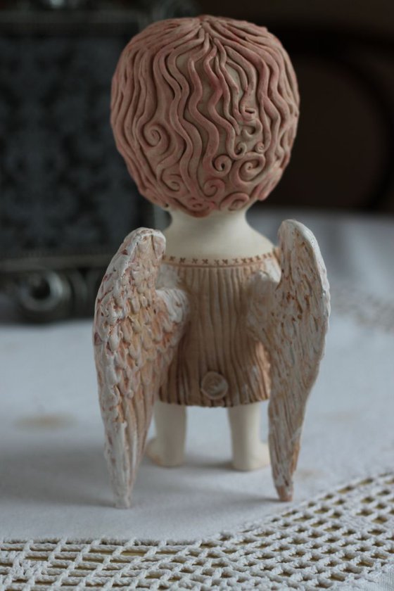 Angel holding a mask. Ceramic OOAK sculpture.