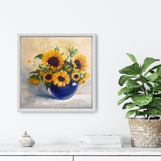 Sunflowers bouquet in a blue glass vase still life