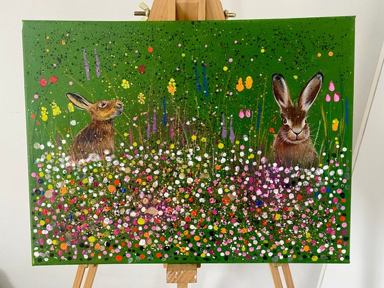 Hares in the meadow. Acrylic painting