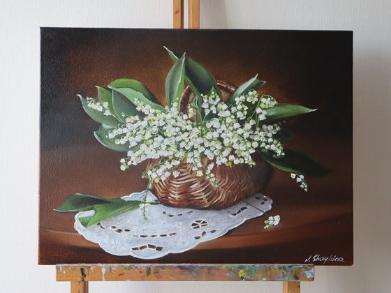 Lilies of the valley in rustic basket