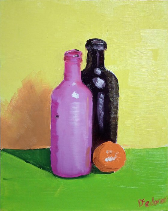 Colourful still life with two bottles and an orange tangerine