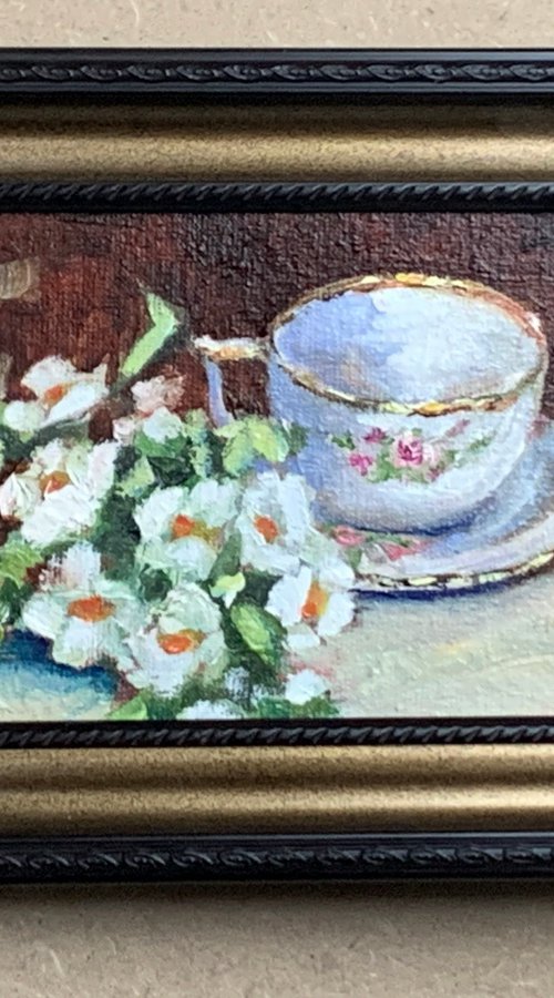 Tea cup with white flowers. by Vita Schagen