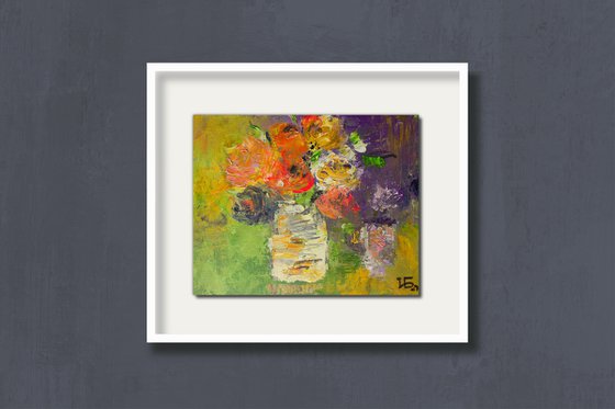 Small still life with bright colorful flowers in the white vase on green and lilac background