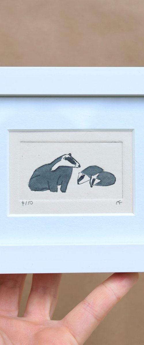 Small framed badger and two young by Sally Fisher