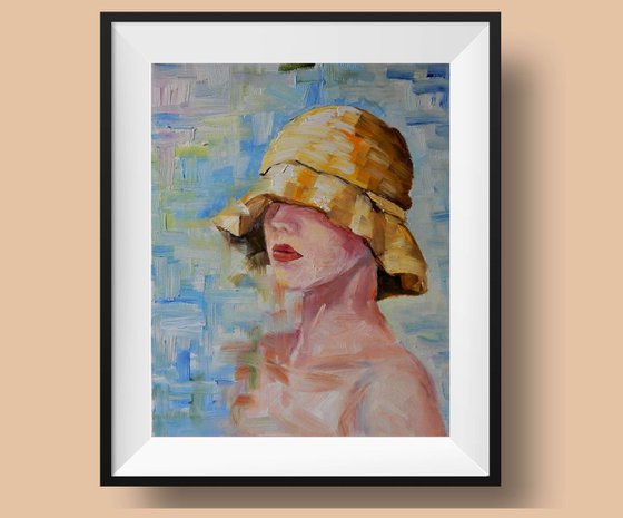 Portrait. Young lady in a yellow summer hat.