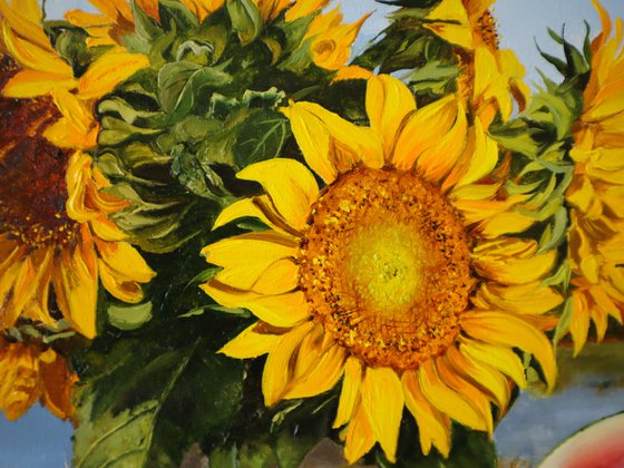 A bouquet of sunflowers in a blue and white vase