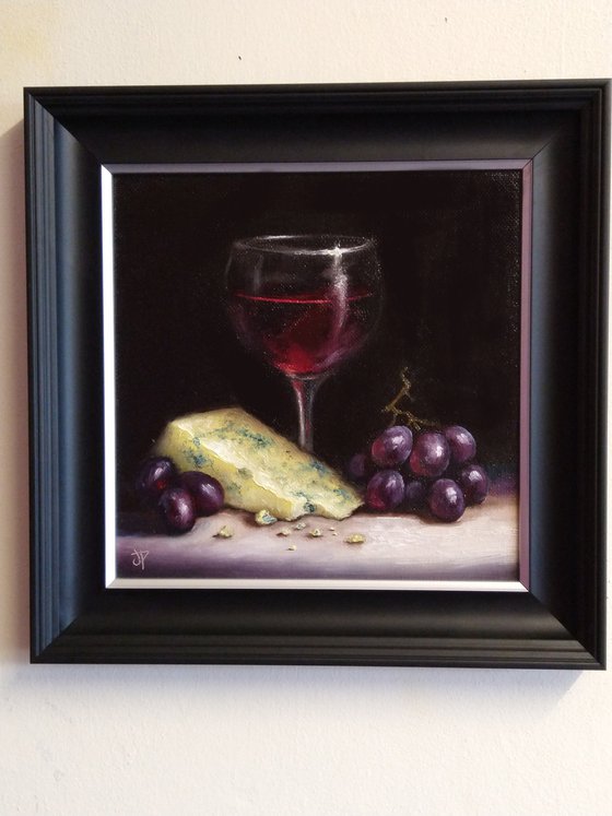 Red wine with cheese and grapes still life