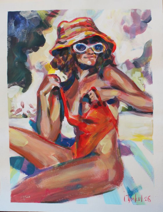 Girl in a red orange swimsuit and panama hat