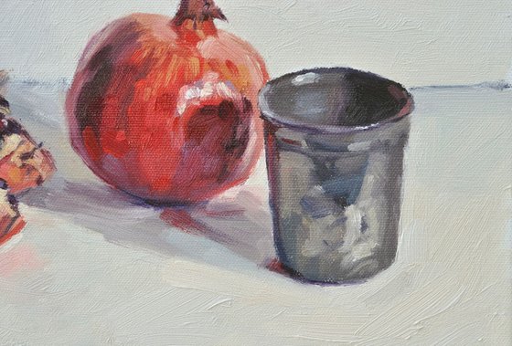 Pomegranates and tin cup