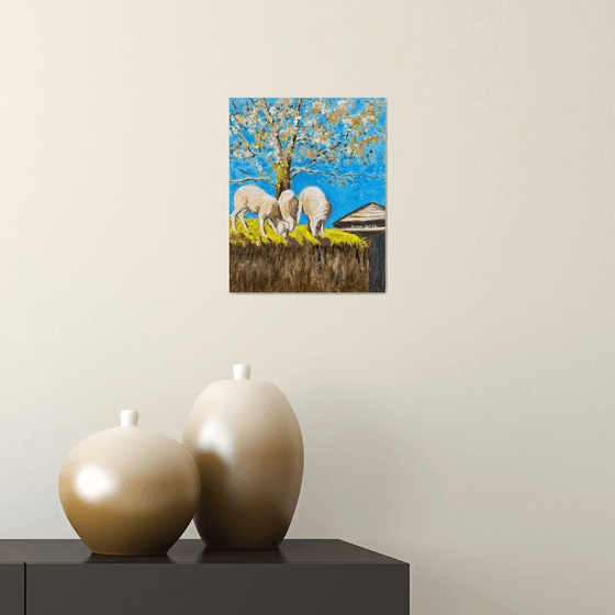 Sheep grazing under a tree