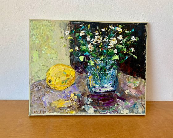 Still life with wildflowers and a lemon