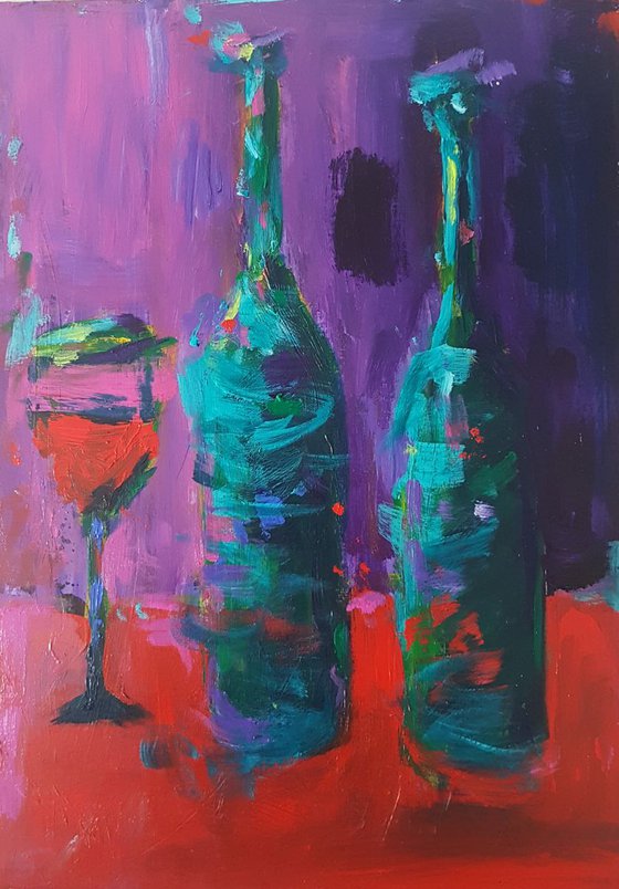 Bottles and a Glass on a Red Table