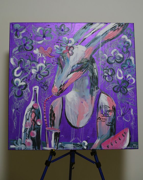 Rabbit with a cocktail in the lilac garden in spring