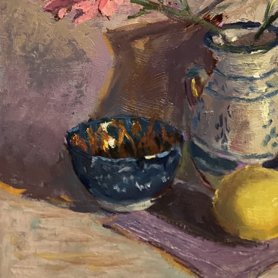 Lemons and flowers with a vase