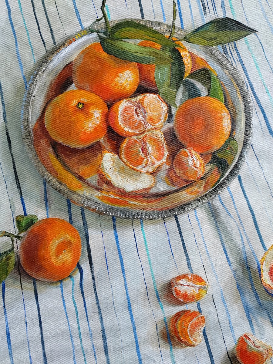 Clementines on stripen tablecloth by Leyla Demir